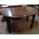 A late Victorian polished oak extending dining table, set on bobbin turned legs