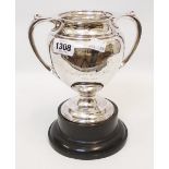An English silver two handled presentation cup with engraved text, on socle base