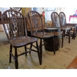 A set of four old wheel back kitchen chairs with moulded solid elm seats stamped GR, set on turned