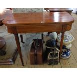 A 35" 19th Century mahogany and strung fold-over tea table, set on slender turned and tapered legs