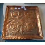 An Arts & Crafts square hammered copper tray with stylized entwined lilies