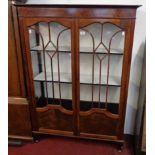 A 3' 6 1/2" 1920's mahogany display cabinet with later painted interior enclosed by a pair of beaded