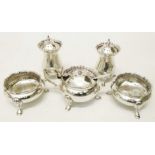 A Chester silver five piece condiment set with decorative rims and shell topped hoof pattern feet,