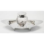 A silver and cut glass inkstand with hinged flip lid to the faceted plug-in well, set on an