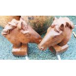 A pair of 12" cast iron horse heads with square plinth bases