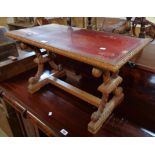 A 31" reproduction stained wood coffee table with leather inset under glass, set on flanking twin