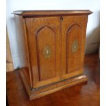 An 11" late Victorian stained oak tabletop stationery cabinet with printed decoration to fall