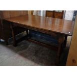 A 5' Old Charm polished oak refectory style table with brackets to apron, turned supports and