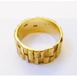 A hallmarked 18ct. gold bark effect wedding band - London 1972