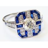 A marked 750 white metal Art Deco style panel ring, set with central diamond on diamond encrusted