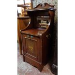 An Edwardian walnut inlaid and strung coal perdonium with shaped pediment, bevelled mirror set