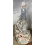 A Lladro figure of a woman and pigs - one pig missing