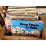 A box containing a collection of vinyl LPs records including 'In Rock' by Deep Purple, 'Alchemy'