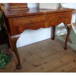 A 3' 3 1/4" early 20th Century walnut cross banded and strung lowboy style side table with two