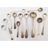 A small collection of English silver salt and mustard spoons and a marked 925 white metal