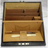 A Victorian leather clad stationery box with fall front and fitted interior