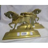 A pair of brass horse pattern doorstops