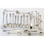 A collection of foreign decorative white metal small spoons of varying design, also pair of scorpion