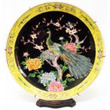 A late Meiji period Japanese Famille Noire charger depicting peacock and hen among chrysanthemum and