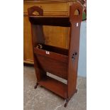 A 17 1/4" Edwardian walnut and strung two tier magazine trough with pierced standard ends and