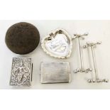 A silver mounted pin cushion, inscribed heart shaped pin tray, match book case, Anglo Indian white