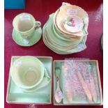 A collection of Carltonware primula pattern including small dish, cup with saucer, butter knives,