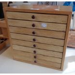 A 12 1/2" mixed wood collector's chest of eight drawers - sparse printing block contents