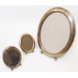 A 7 3/4" marked 925 gilt metal fronted oval photograph frame - sold with two 3 1/4" similar
