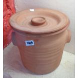 A modern terracotta lidded bread crock with glazed interior