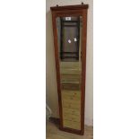 An Edwardian walnut framed narrow bevelled oblong wall mirror