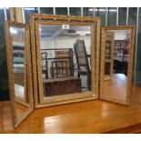 A 20th Century ornate gilt framed triple dressing table mirror