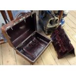 A vintage brown pigskin vanity case with Gladstone style action enclosing a red leather interior and