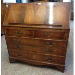 A 3' 1 1/2" reproduction mahogany and cross banded bureau with fitted interior, two short and
