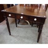 A 35" Victorian mahogany side table with three frieze drawers (one replacement), set on turned and