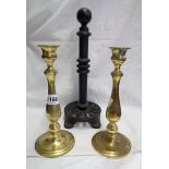 A pair of brass candlesticks - sold with a cast iron kitchen roll holder