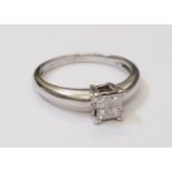 An imported 750 white metal ring, set with four paved small diamonds - 0.2ct. TDW
