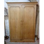 A 4' 8" Victorian waxed pine double wardrobe with moulded cornice, hanging space and four drawer