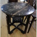 A 23 3/4" diameter 1920's eastern ebonised wood occasional table with decorative mother-of-pearl