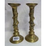 A pair of oriental brass candlesticks with entwined dragon decoration