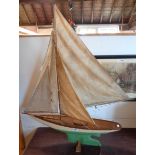 A mid 20th Century pond yacht with sails and painted hull, in fitted pine box - hull length 30"