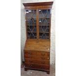 A 22" late 19th Century mahogany bureau bookcase with moulded cornice and astragal glazed panel