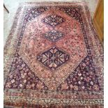 An early 20th Century Hamadan wool rug with conjoined medallions and spandrels on a millefiore and