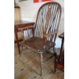 An old wheel back carver chair with solid elm seat, set on ring turned supports - screw repairs