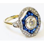 A marked 750 yellow metal Art Deco style oval panel ring, set with central diamond within a paved