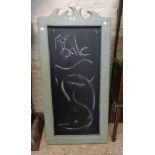 A painted wood framed easel blackboard with decorative shaped top