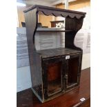 A late Victorian stained wood wall cabinet with two open shelves and pair of glazed doors under -