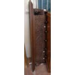 A 4' 3 1/2" late Victorian carved stained oak wall mounted coat rack with moulded top, flanking