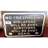 A painted cast iron novelty trespass sign