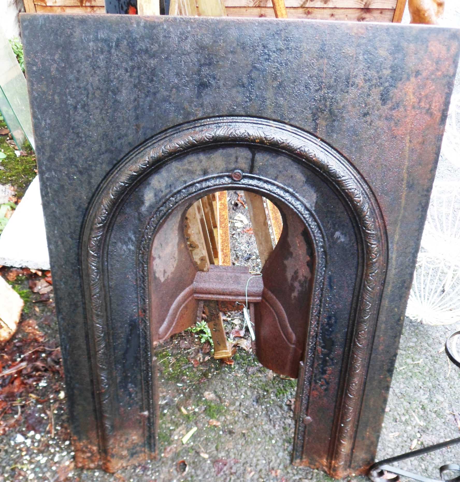 A Victorian cast iron arch fronted bedroom fire surround