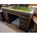 A 4' 6" early 20th Century mahogany twin pedestal desk with tooled green leather inset top, three